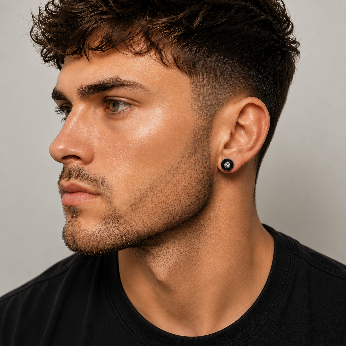 Male model close-up wearing black crystal Greek key stud earring